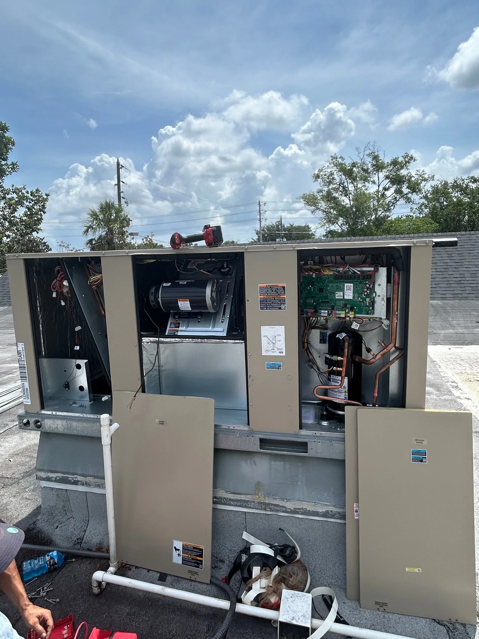 Open commercial rooftop package HVAC unit during project work