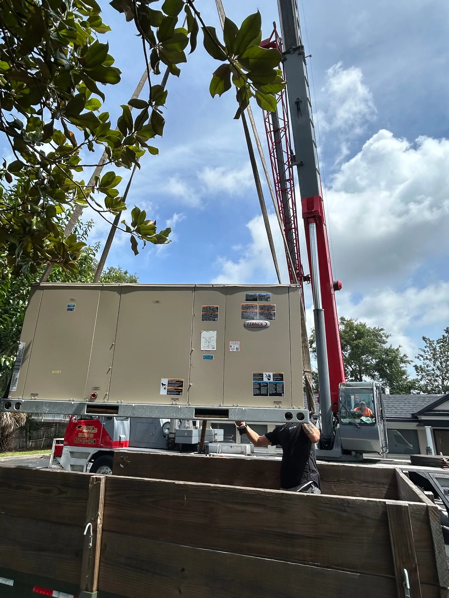 Commercial rooftop HVAC unit being set by crane
