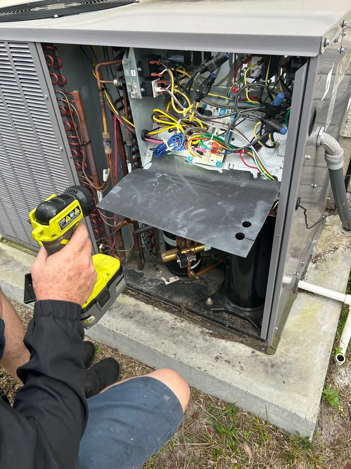 Heat pump opened for HVAC repair and diagnostic work