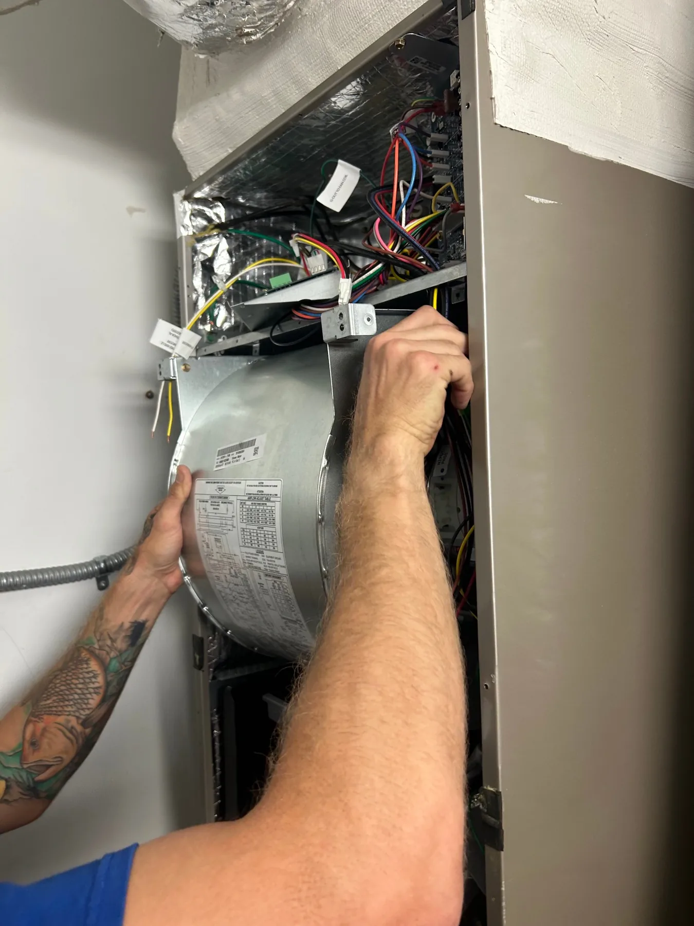 Coolmore technician servicing the inside of an air handler